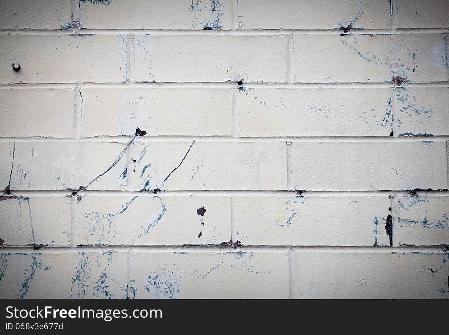 White brick wall with blue spots