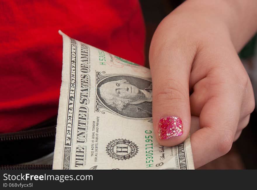 Young girl giving change back to customer. Young girl giving change back to customer