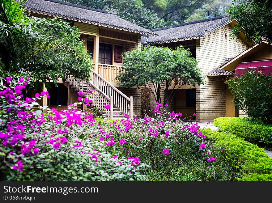 Chinese countryside villa with blooming flower in botanical garden