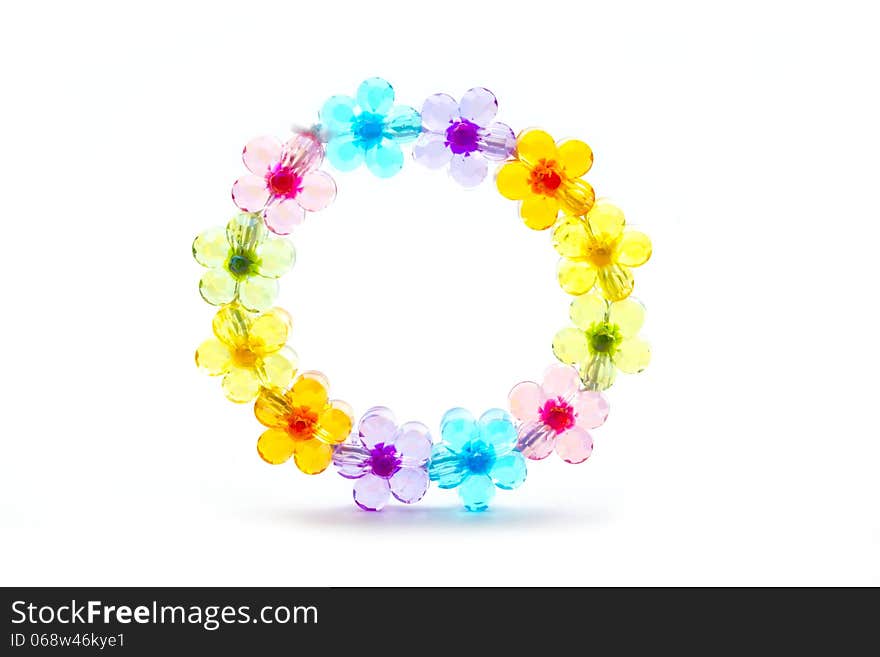 Toy plastic bracelet with flower colorful bead isolated on white. Toy plastic bracelet with flower colorful bead isolated on white