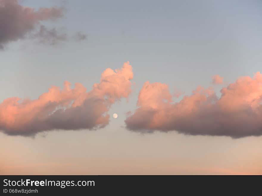 Clouds and Moon at the sunset.