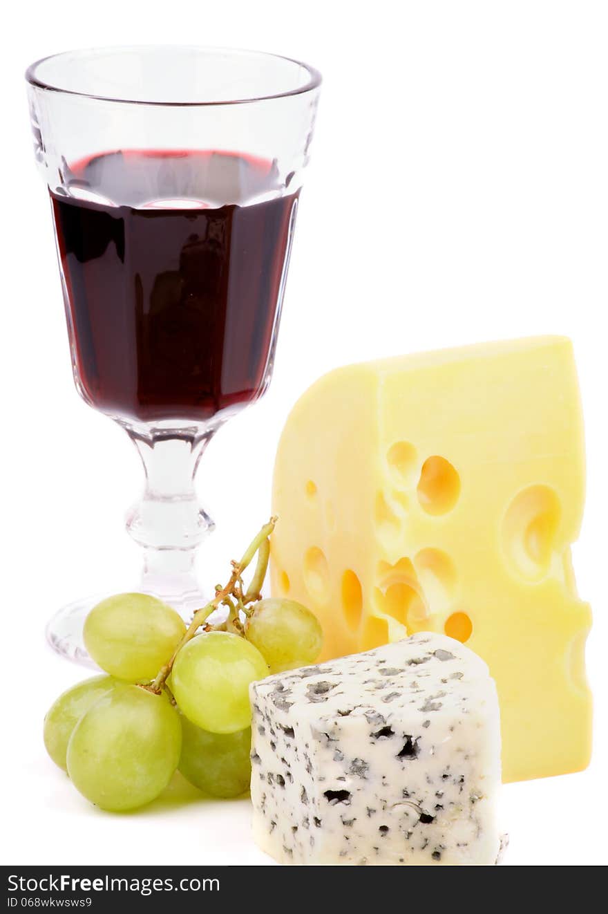 Arrangement of Red Wine, Maasdam Cheese, Dorblu Cheese and Green Grapes isolated on white background. Arrangement of Red Wine, Maasdam Cheese, Dorblu Cheese and Green Grapes isolated on white background