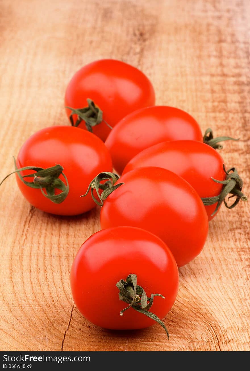 Fresh Ripe Cherry Tomatoes In a Row on Rustic Wooden background