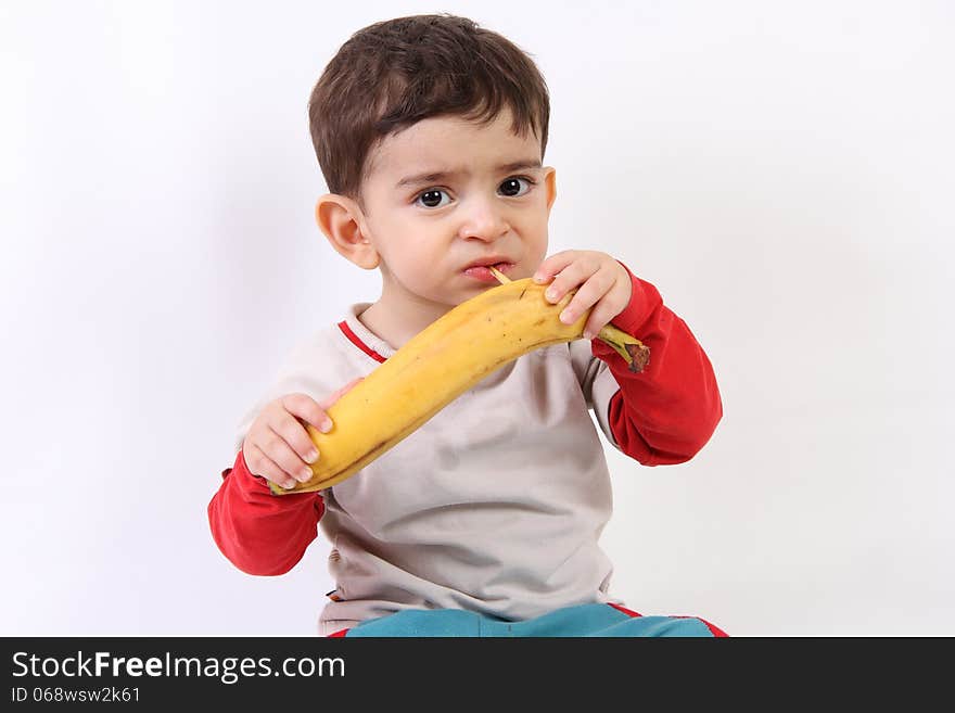 Children eating a big banana. Children eating a big banana