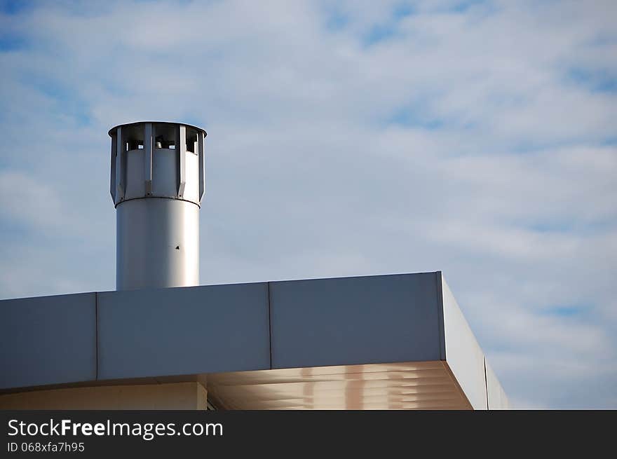 A modern chimney on top of a recent building