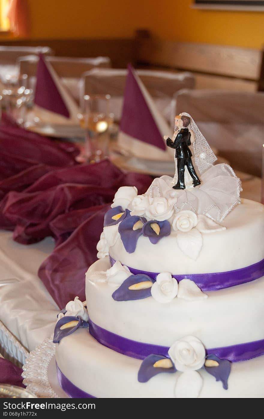 Beautiful Wedding Cake with purple calla lilys and white roses.