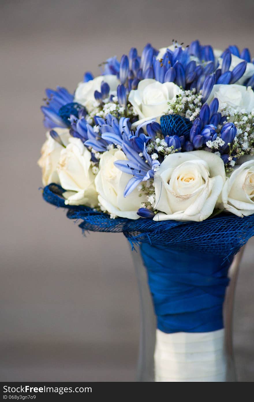 Wedding Bouquet made of white roses and blue agapantus.