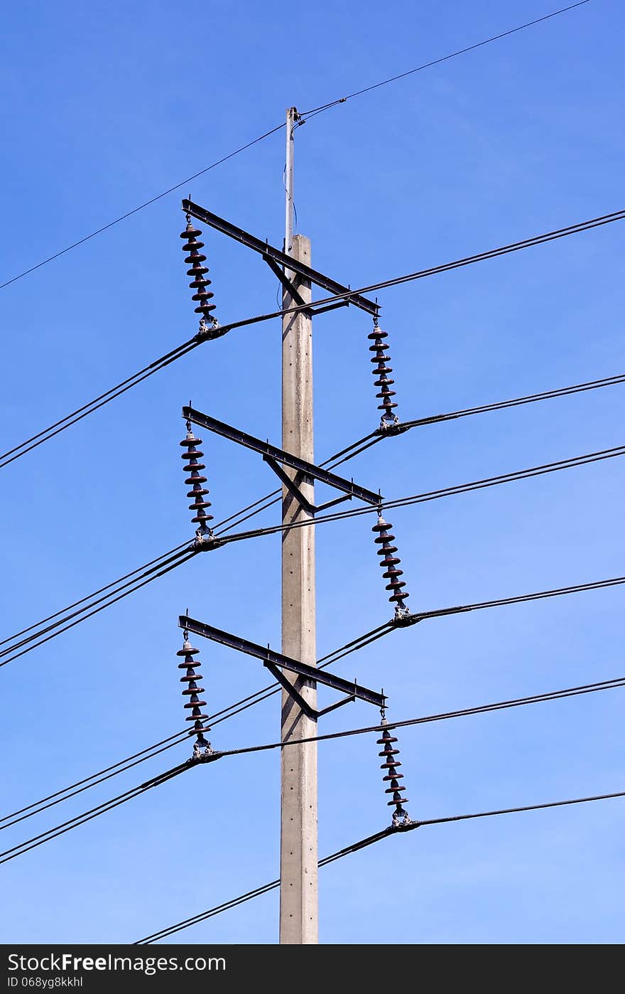 A single electricity post with blue sky