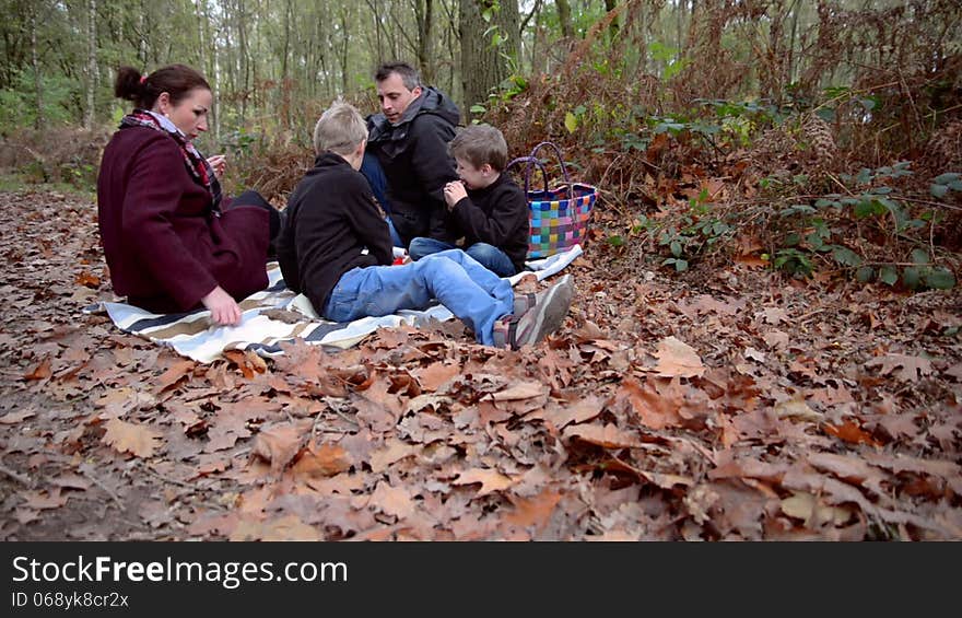 Family having a picnic in a forest. Family having a picnic in a forest