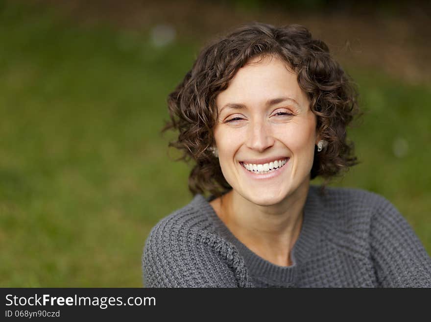 Close-up of a woman smiling at the park