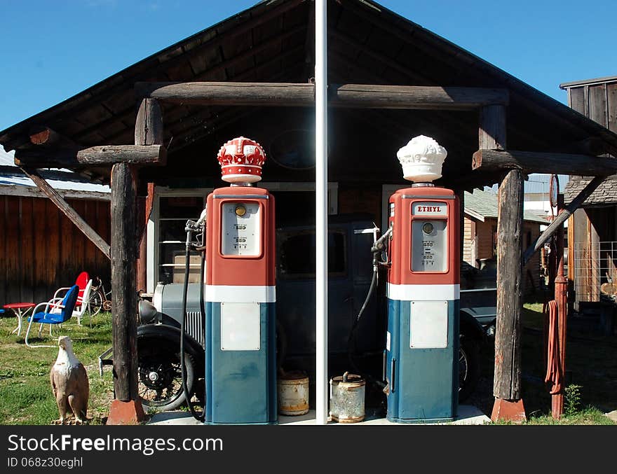 Famous Red Crown Standard gas station as great retro historical mark ,nearby retro car of that time eagle as american symbol. Famous Red Crown Standard gas station as great retro historical mark ,nearby retro car of that time eagle as american symbol