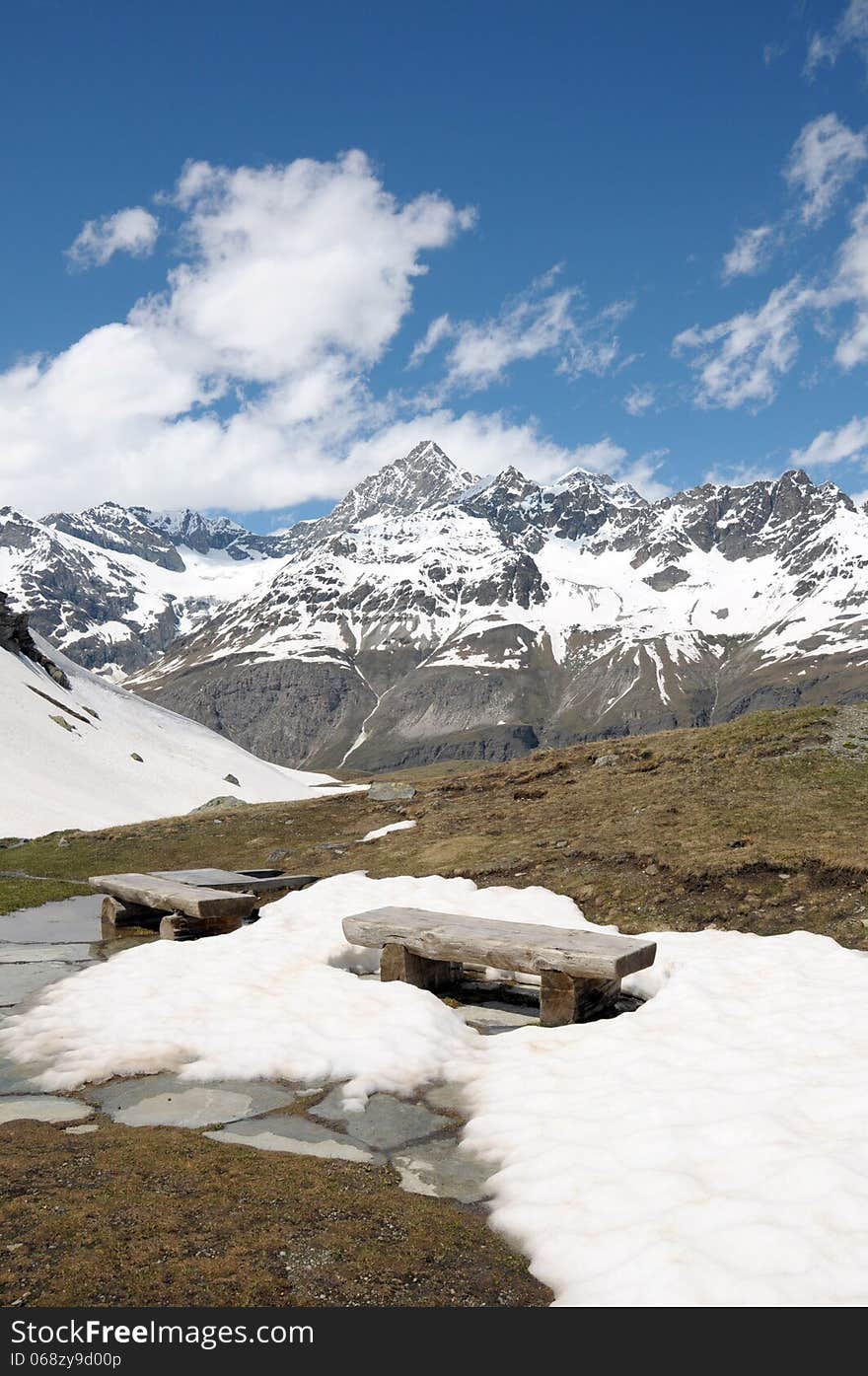 Bench in snow on path above Schwarzsee in Swiss Alps. Bench in snow on path above Schwarzsee in Swiss Alps