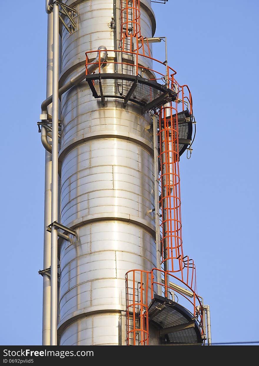 Detail of distillation tower in sunny day and blue sky. Detail of distillation tower in sunny day and blue sky