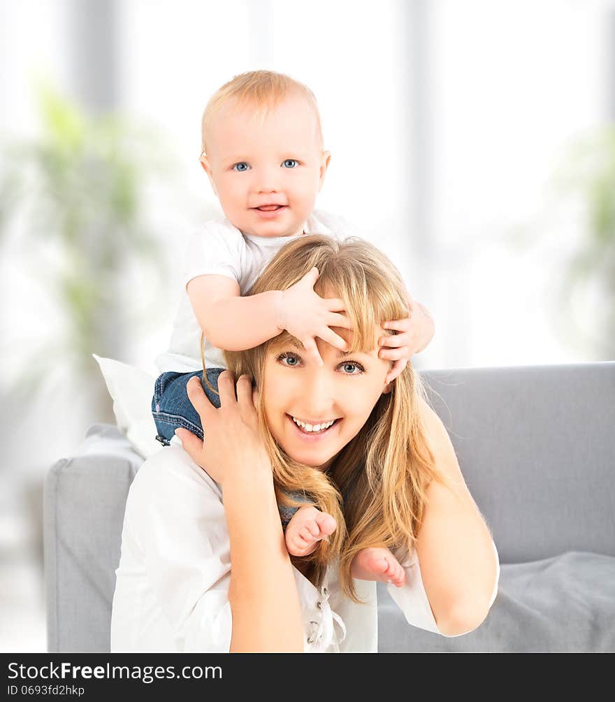 Happy Family. Baby Sits Astride The Shoulders Of The Mother