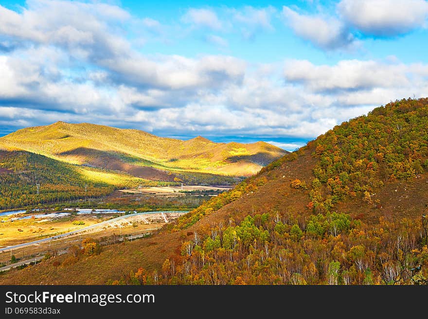 Autumn woods and mountains cloudscape