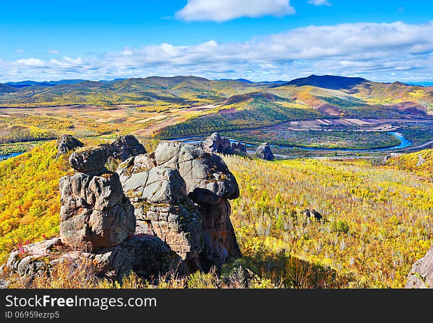 The megalith and autumn forest and river