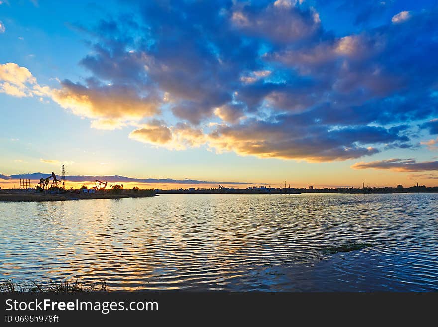 The Oil fields in the afterglow lake and cloudscape