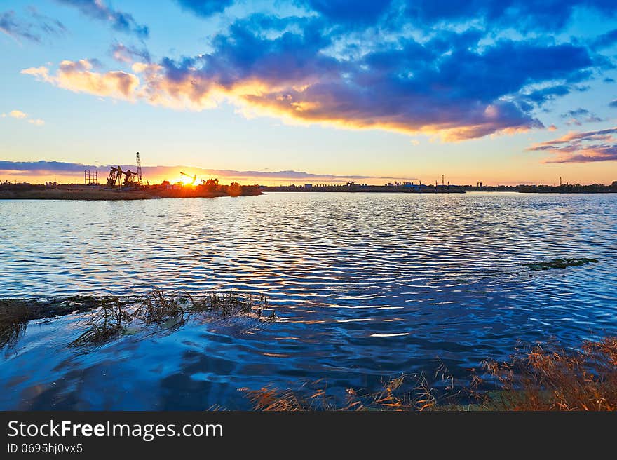 The Pumping Unit And Lake In The Afterglow