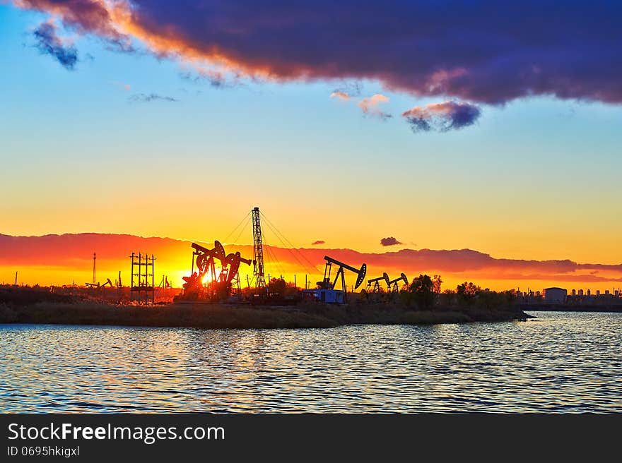 The oil fields and lake sun setting