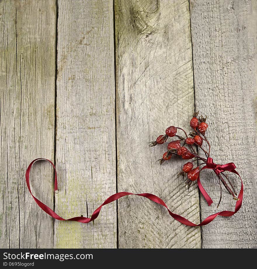 Vintage frame with berry bunch on wooden background