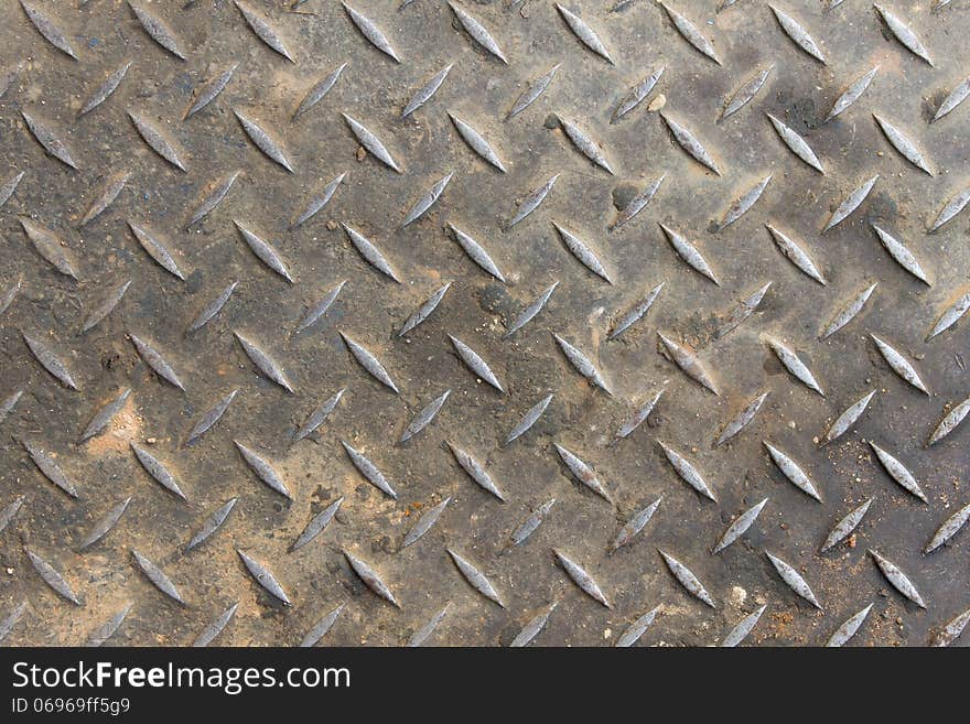 Old diamond plate background and small sand with dirt