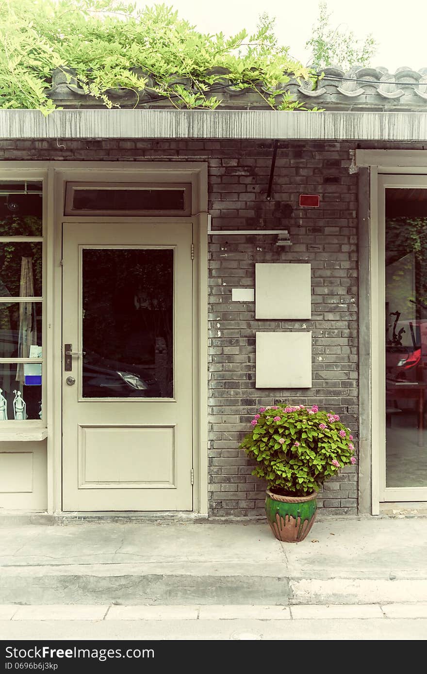 Flowerpot at store entrance, China.