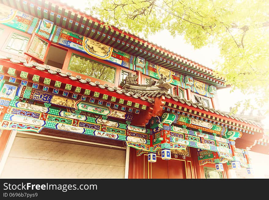 Chinese traditional construction roof with green tree leaves