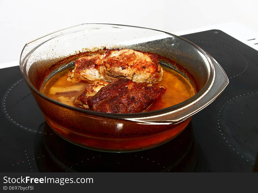 Natural pork cutlets in a glass bowl. Natural pork cutlets in a glass bowl