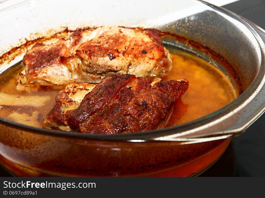 Detail of natural cuttings in a glass bowl, pork chops in brine