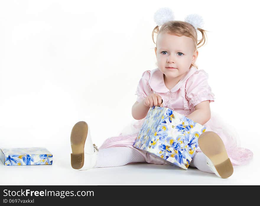 Little girl opening the present, isolated on white background