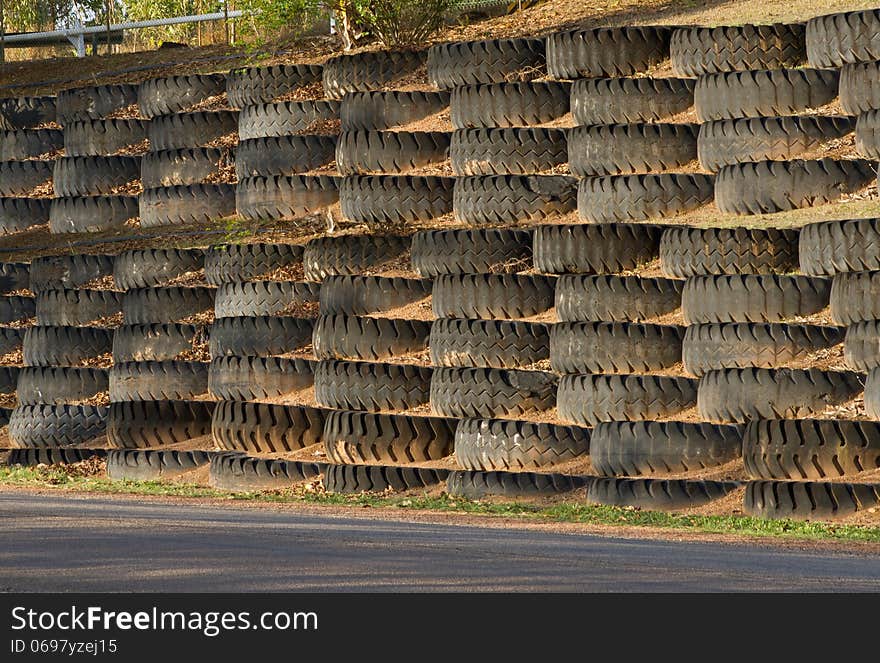 Ripped and tear apart in a rough or vigorous manner heavy transport mine truck wheel piled as blocks