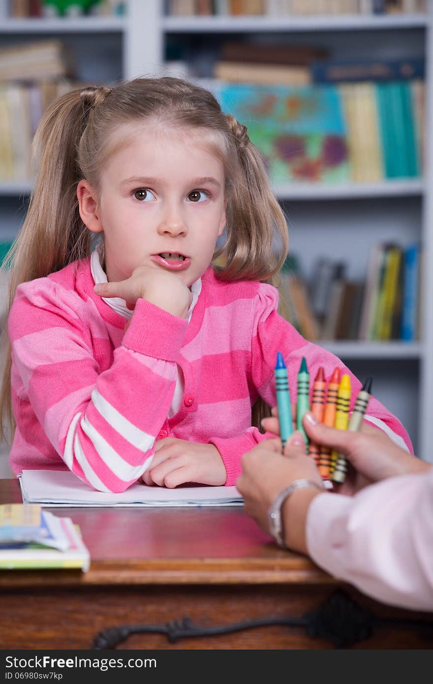 Child chooses the color pencils