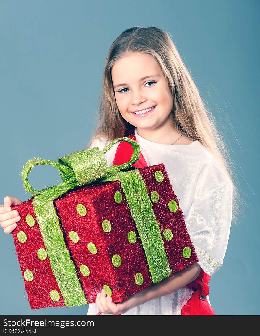 Little girl holding a big red gift boxes. Little girl holding a big red gift boxes