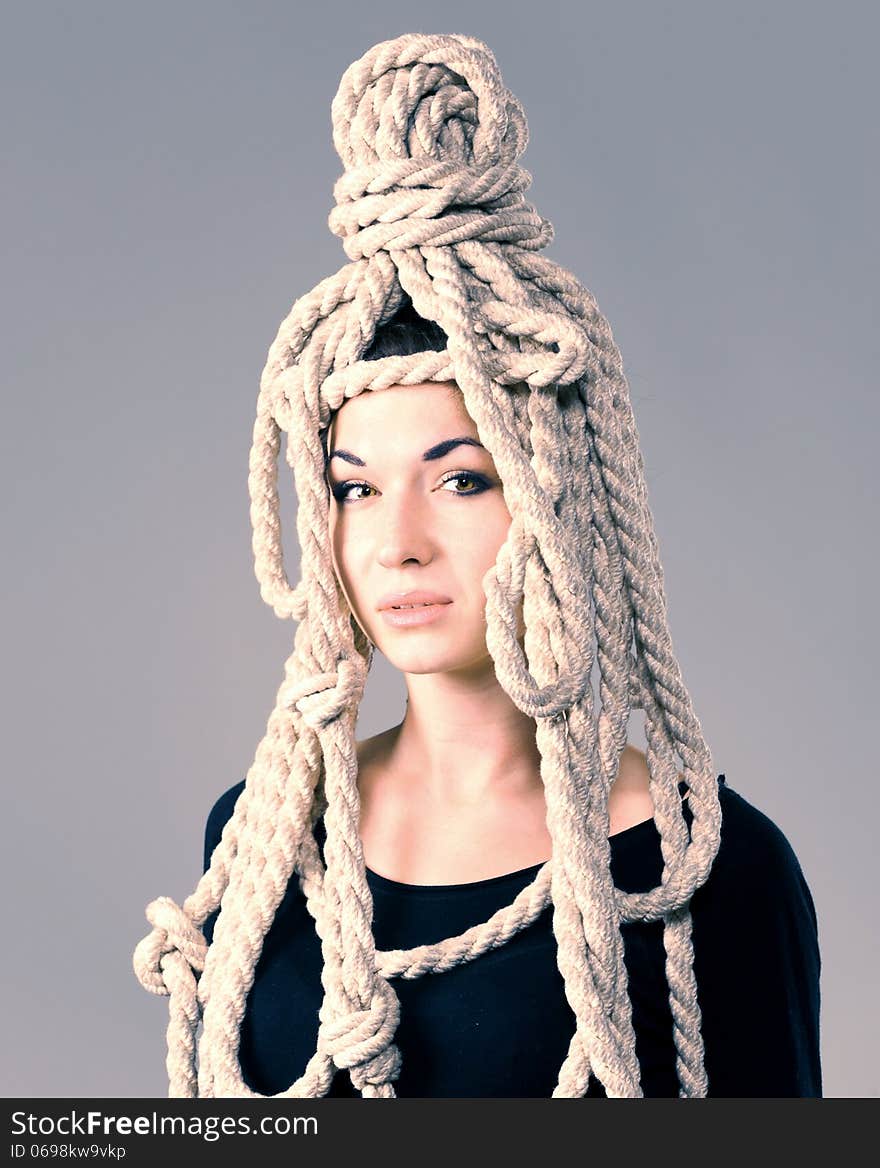 On the head of a young girl headdress made ​​of rope. On the head of a young girl headdress made ​​of rope