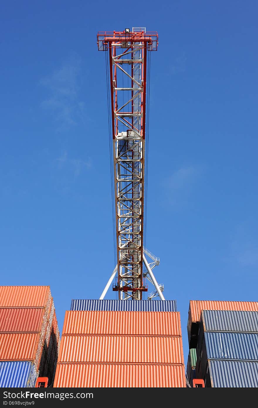 Crane and container boxes at an international container port. Crane and container boxes at an international container port.