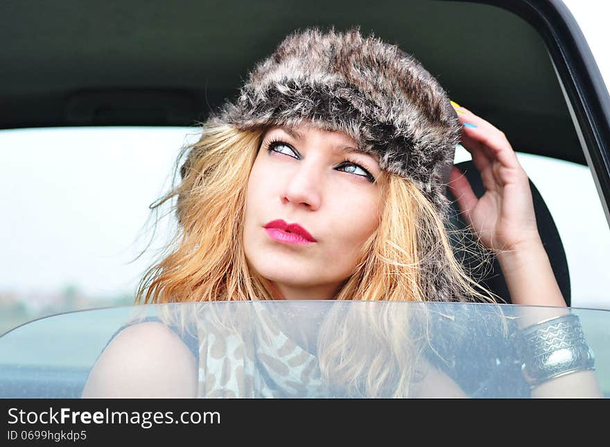 Portrait of beautiful fashion girl model in a car. Portrait of beautiful fashion girl model in a car.