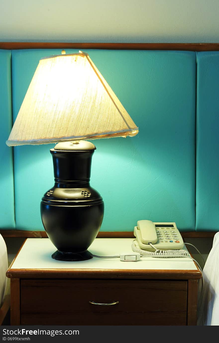 Table lamp and phone on bedroom