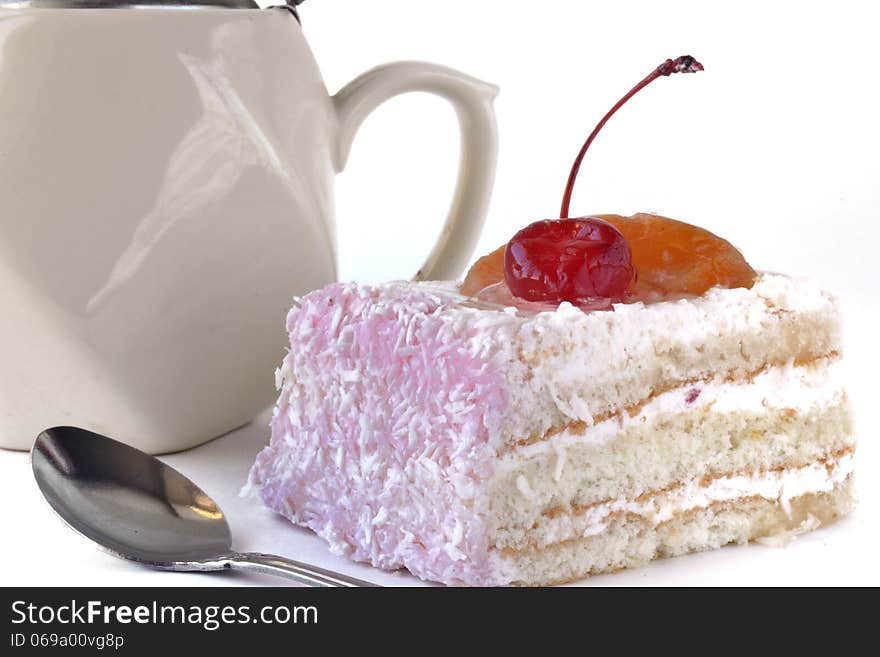 Sliced cake, kettle and teaspoo isolated on white background