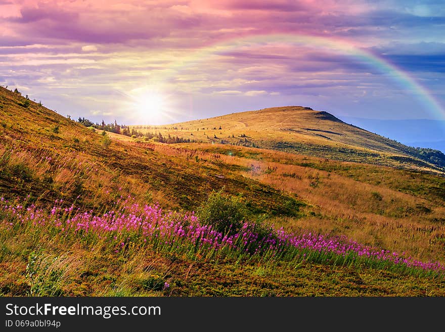 Mountain landscape. valley with stones on the hillside. forest on the mountain under the beam of light falls on a clearing at the top of the hill. Mountain landscape. valley with stones on the hillside. forest on the mountain under the beam of light falls on a clearing at the top of the hill.