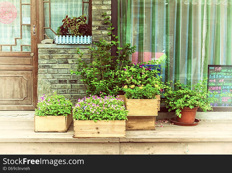 Flowers in wooden pot at the store entrance