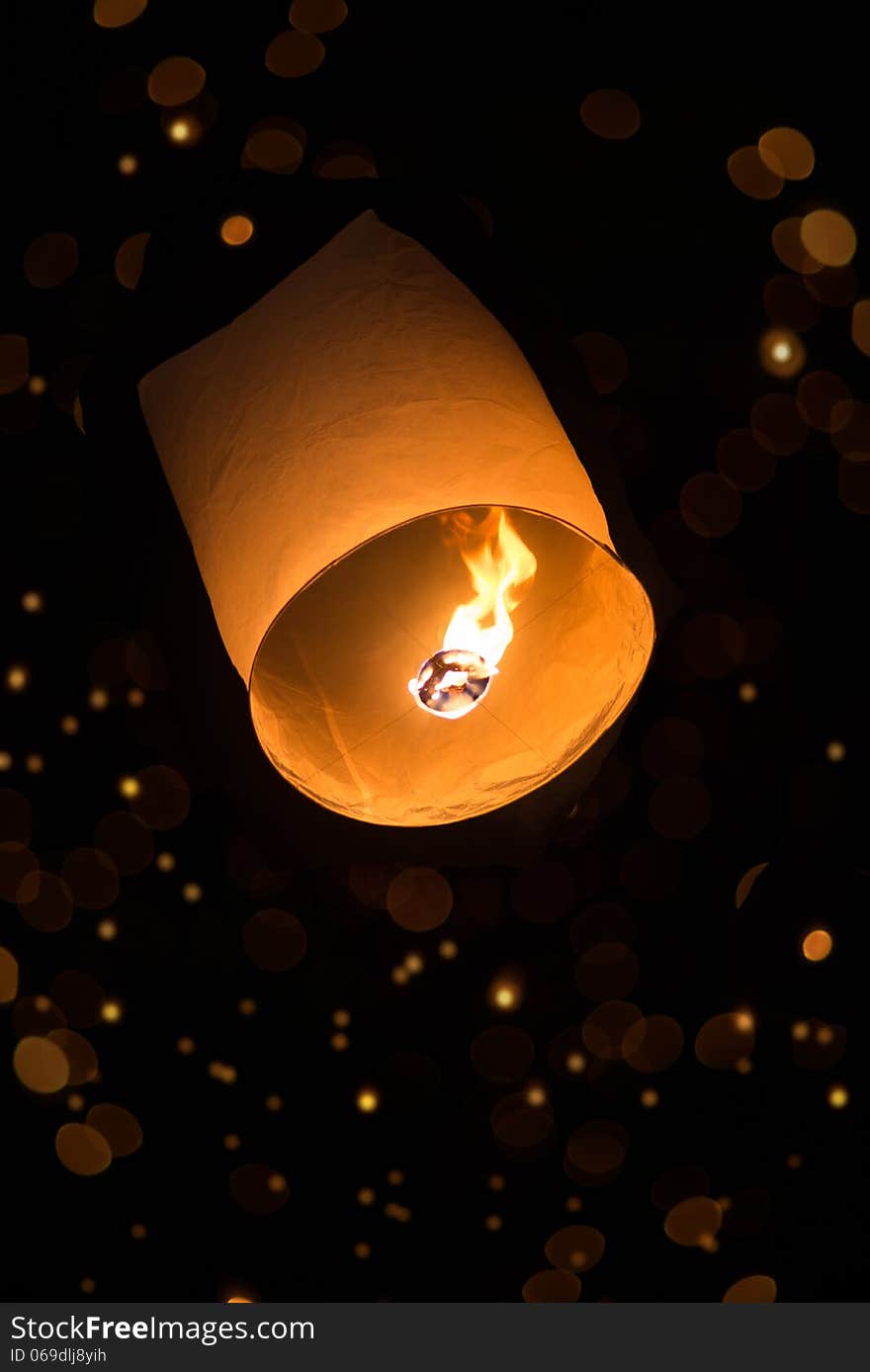 Hot air sky lantern with bokeh in the dark