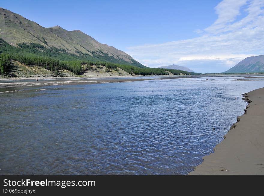 Sunny landscape of the river in mountains.