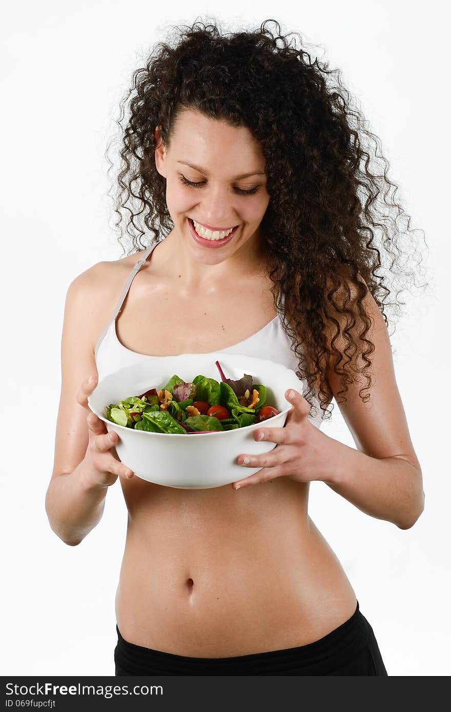 Portrait of beautiful young mixed woman with salad, isolated on white