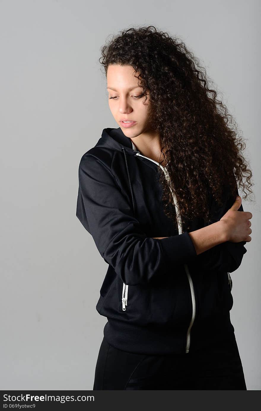 Portrait of young cheerful smiling woman in sports wear