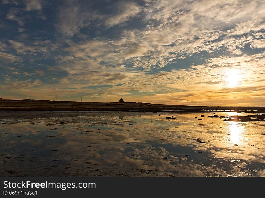 Wintersunset in Álftanes Iceland with a silhouette of a house, very nice background material. Wintersunset in Álftanes Iceland with a silhouette of a house, very nice background material