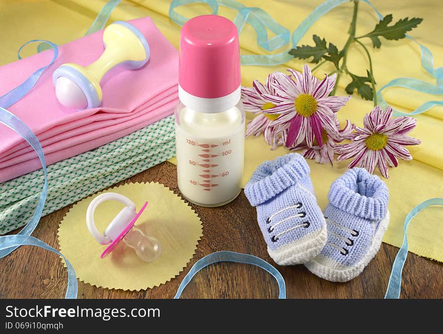 Baby still life with milk bottle, pacifier and plaything. Baby still life with milk bottle, pacifier and plaything