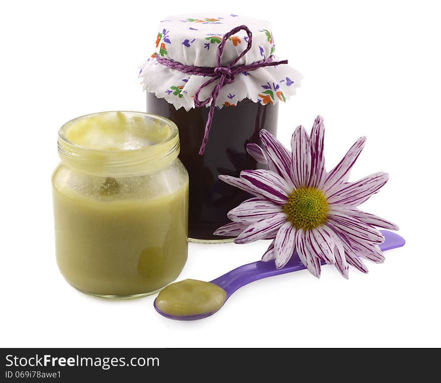 Baby food still life with pureed jars, spoon and flower. Baby food still life with pureed jars, spoon and flower