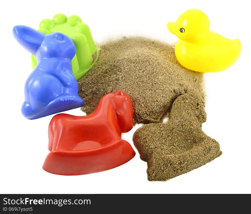 Colorful kids toys for sandbox with pile of sand isolated. Colorful kids toys for sandbox with pile of sand isolated