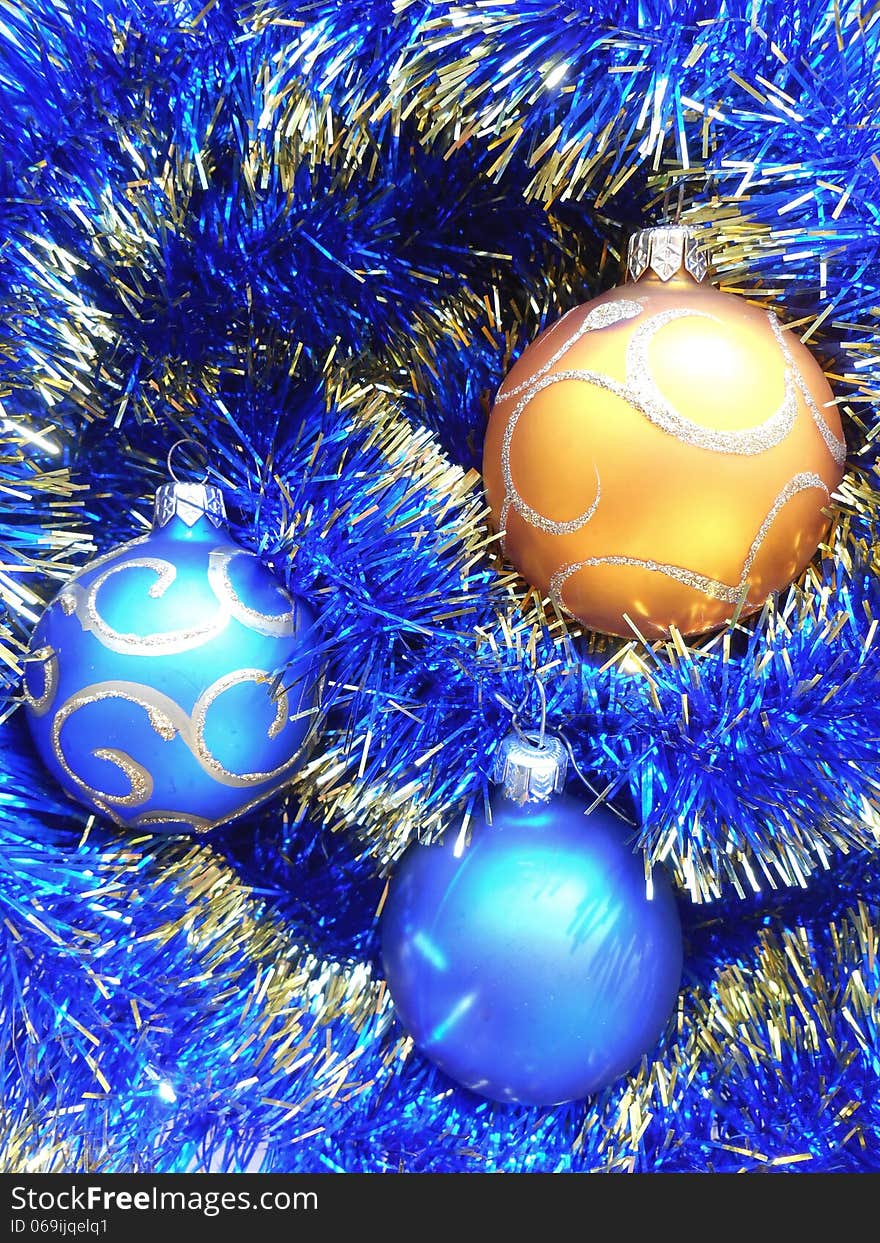 Christmas and New Year balls blue and gold tinsel background. Christmas and New Year balls blue and gold tinsel background