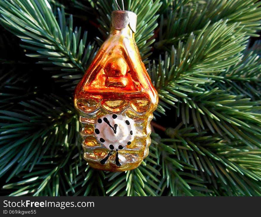 Christmas and New Year decoration gold watch on a background of green firtree